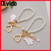 Móc khóa hoa anh đào OLVIDO, dây chuyền cườm ngọc trai mặt chữ - phụ kiện túi tai nghe sang trọng, giá ưu đãi 42.120₫