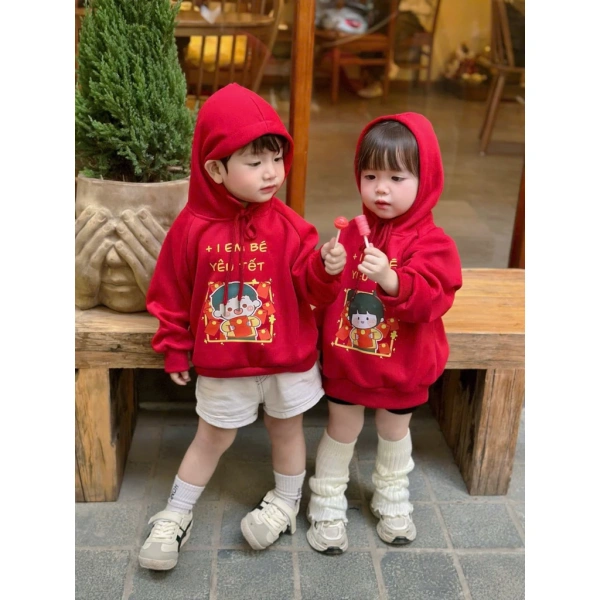 Áo hoodie đỏ in hình Tết cho bé: Khi sự ấm áp bất ngờ khiến con ngại di chuyển trong những buổi chiều nắng.